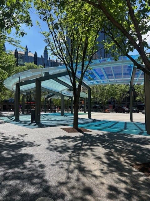 Pittsburgh public plaza with canopy and skyline details in the background